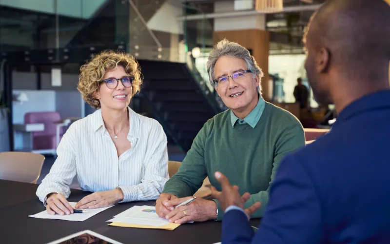 couple speaking to a financial advisor